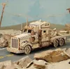 A wooden model of a heavy truck is displayed on a road with rocks and a desert-like background. Náhľad obrázku produktu