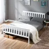 A white wooden bed frame with gray bedding and a white fluffy throw is shown in a bedroom setting. Produktbild-Vorschau