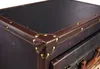A close-up view of the corner of a vintage-style trunk or storage unit. Podgląd zdjęcia produktu