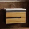 A modern bathroom vanity with a ceramic sink and two wooden drawers, set against a tiled wall. Produktbild-Vorschau