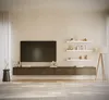 A modern living room with a wall-mounted TV stand and shelves. Produktbild-Vorschau