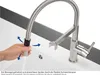 A hand is shown manipulating a flexible kitchen faucet spout over a sink. Anteprima dell’immagine prodotto