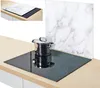 A glass hob cover with a marble pattern is placed on a stovetop, with a pot on the hob. Anteprima dell’immagine prodotto
