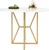 A round dining table with a marble-effect top and gold legs, set against a white background. There are some green apples in a black bowl and a decorative tray with bottles on the table. Voir les images du produit
