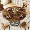 A round dining table set for a meal in a dining room with chairs and kitchen cabinets in the background. Podgląd zdjęcia produktu