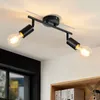 A black ceiling light fixture with two adjustable spotlights, each with an exposed Edison-style bulb, mounted on a white ceiling. Náhľad obrázku produktu