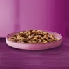 A close-up shot of cat food in a pink bowl, set against a blurred purple background. Produktbild-Vorschau