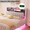 A bed with a headboard featuring storage and LED lighting, with pillows and a blanket on the mattress. Náhled obrázku produktu