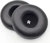 Two black ear pads for headphones are shown on a white background. Voir les images du produit