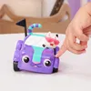 A child's hand is pressing on a purple toy car with a cat figure inside. Anteprima dell’immagine prodotto