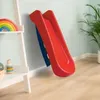 A red slide is leaning against a light blue wall, next to a white shelf with toys. Anteprima dell’immagine prodotto