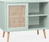 A light green sideboard with a rattan cane door and wooden legs, displayed in a studio setting against a white background. Produktbild-Vorschau