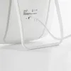 Close-up of the back of a white Xiaomi Mijia LED makeup mirror, showing the charging port and a red indicator light. Podgląd zdjęcia produktu