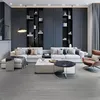 A modern living room with a sectional sofa, coffee tables, and built-in shelving. Produktbild-Vorschau