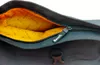 A close-up view of the inside of a bag, showing the zipper and the orange lining with a repeating pattern. Produktbild-Vorschau