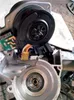 A close-up view of a disassembled automotive steering column component, likely an electric power steering motor and associated electronics. Náhľad obrázku produktu