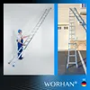 A collage of two images showing a telescopic ladder. The left image shows a man in work clothes using the ladder indoors against a white wall. The right image shows the ladder set up outdoors against a house. Náhľad obrázku produktu
