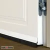 A close-up view of a white door with a black brush seal attached to the bottom. Náhled obrázku produktu