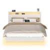 A white bed frame with a headboard featuring LED lighting and shelves, set against a white background. Náhled obrázku produktu