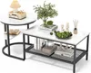A set of two nesting coffee tables with a white marble pattern and black metal frames, styled with decorative items. Voir les images du produit