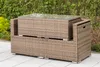 A wicker outdoor furniture set with a glass top table is placed on a patio with greenery in the background. Produktbild-Vorschau
