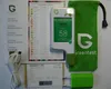 A flat lay of a Greentest device and its accessories, including manuals, a charging cable, a power adapter, and a carrying pouch. Produktbild-Vorschau