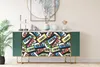 A green sideboard with a cassette tape pattern on the doors, displayed in a room setting. Náhled obrázku produktu