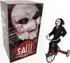 A product box and a figure of Billy the Puppet on a tricycle. Produktbild-Vorschau