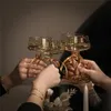 Four hands clinking champagne glasses decorated with golden ribbons. Produktbild-Vorschau