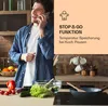A man is on the phone in a kitchen with food preparation items on the counter. A marketing overlay is present. Produktbild-Vorschau