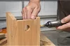 A person is using a cordless electric screwdriver to assemble a wooden birdhouse. Produktbild-Vorschau