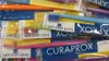 A close-up view of several packaged toothbrushes in various colors. Náhled obrázku produktu