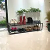 A shoe rack with various shoes and boots on it, placed in a hallway or entryway. Náhled obrázku produktu
