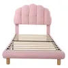 A pink upholstered bed frame with a slatted wooden base, shown from the front on a white background. Produktbild-Vorschau