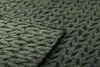 A close-up view of a green blanket with a dark green pattern. Produktbild-Vorschau
