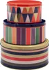 A stack of three round decorative tins with colorful geometric and striped patterns. Produktbild-Vorschau