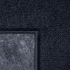 A close-up view of the corner of a dark blue carpet, showing the texture of the pile and the backing material. Produktbild-Vorschau