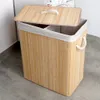 A bamboo laundry basket with a lid is shown in a laundry room setting, next to a washing machine. Náhled obrázku produktu
