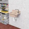 A utility sink mounted on a concrete wall in a garage or workshop setting, with storage bins and tools visible. Produktbild-Vorschau