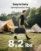 A man walks past tents in a grassy field, carrying a black bag. Dimensions and weight are displayed. Voir les images du produit