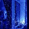 A window decorated with blue LED string lights, creating a festive atmosphere. Náhled obrázku produktu