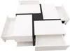 A modern, white coffee table with black accents and four open drawers, shown from a top-down perspective against a white background. Produktbild-Vorschau