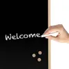 A hand writing 'Welcome' on a chalkboard. Produktbild-Vorschau
