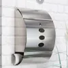 A stainless steel mailbox mounted on a white brick wall. Produktbild-Vorschau
