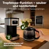 A coffee maker and a hand holding a coffee pot on a kitchen counter. Anteprima dell’immagine prodotto
