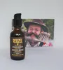 A bottle of Reuzel Beard Serum is placed in front of a postcard featuring a man with a large beard. Podgląd zdjęcia produktu