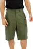 A person wearing olive green cargo shorts. Náhled obrázku produktu