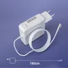 A white laptop charger with a coiled white cable and a magnetic connector, set against a light purple background. Podgląd zdjęcia produktu