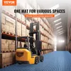 A forklift in a warehouse with shelves of boxes and a blue mat on the floor. Podgląd zdjęcia produktu