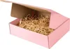 An open pink cardboard box filled with shredded paper packaging. Podgląd zdjęcia produktu